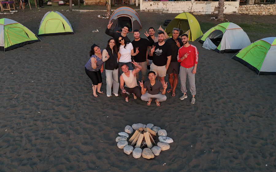 The group at a beach camp on the Syrian coast, with tents and a campfire