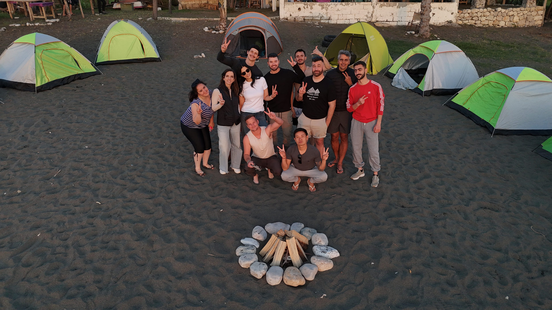 The group at a beach camp on the Syrian coast, with tents and a campfire
