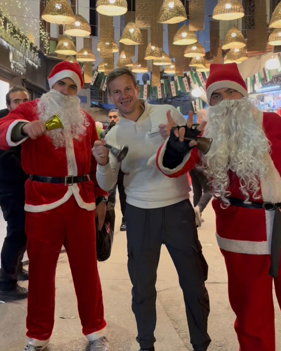 Nick with two Santas at a Christmas market in Damascus